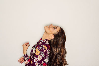 Woman standing against white background