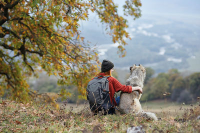 Rear view of man sitting on land