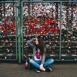 Full length of woman standing by railing