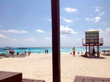 People on beach against sky