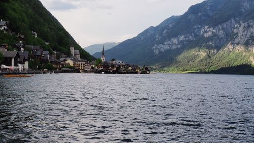 Scenic view of river and mountains against sky