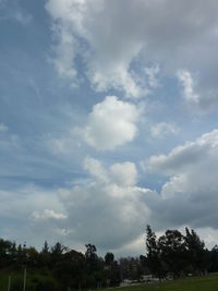 Scenic view of grassy field against cloudy sky