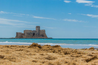 Buildings on beach against sky