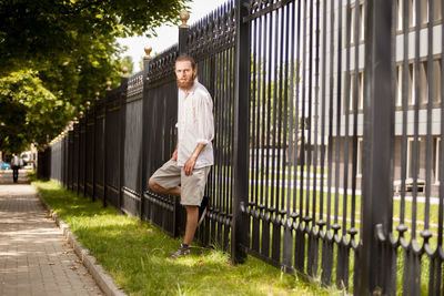 Rear view of man standing on footpath