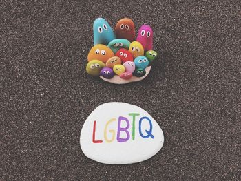 High angle view of multi colored text on pebbles