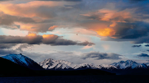 Scenic view of mountains against cloudy sky