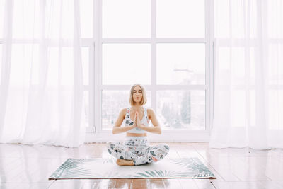 Woman sitting by window