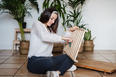 Woman working on wood at home