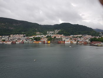 Scenic view of sea by town against sky