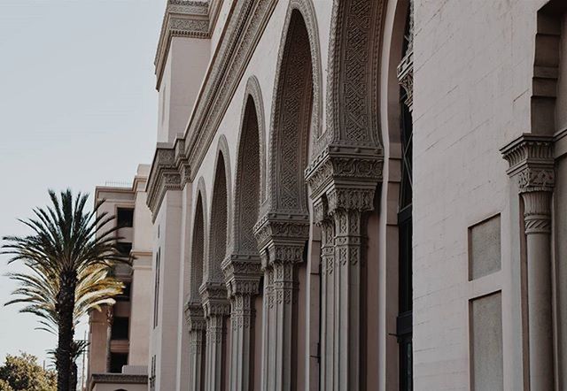 architecture, building exterior, built structure, low angle view, building, window, residential building, city, facade, sky, residential structure, outdoors, architectural column, day, no people, clear sky, exterior, arch, tree, architectural feature