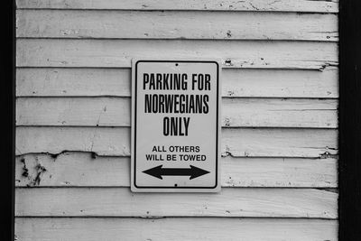 Close-up of information sign on wall