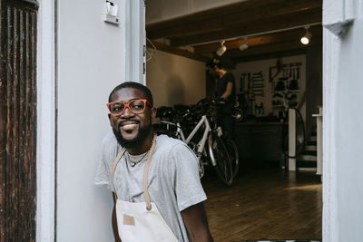 Portrait of young man standing at home