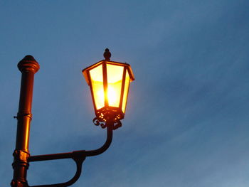 Low angle view of light bulb against sky