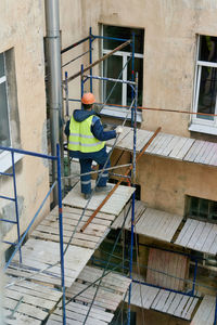 Rear view of man working at construction site in building