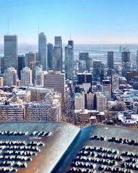 Aerial view of modern buildings in city against sky