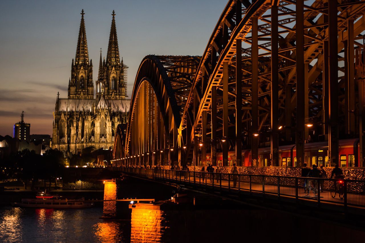 VIEW OF ILLUMINATED BRIDGE AGAINST SKY AT NIGHT