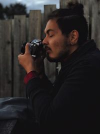 Portrait of young man photographing