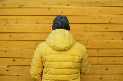 Rear view of man wearing yellow coat