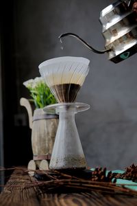 Close-up of person pouring coffee on table