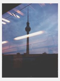 Low angle view of communications tower against sky