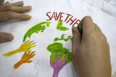 High angle view of hand painting on table