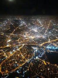 High angle view of city lit up at night