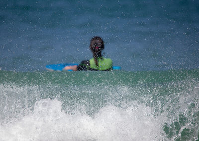 Full length of child on water