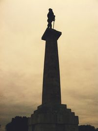 Low angle view of statue of liberty against sky