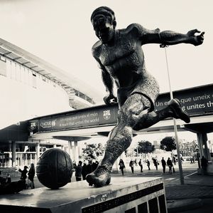 Statue of people in front of building