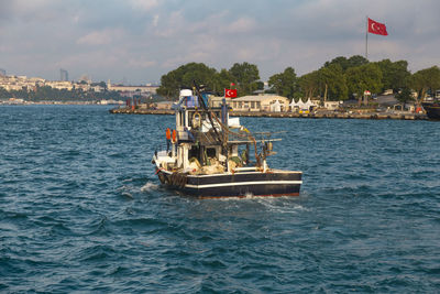 Boats in sea against sky