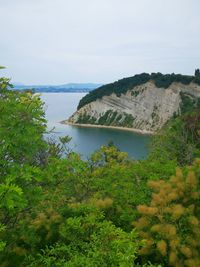 Scenic view of sea and mountains against sky