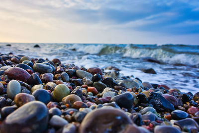 Rocks on beach against sky