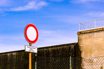 Road sign against sky