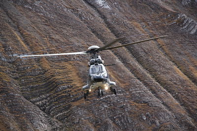 High angle view of man climbing on rock