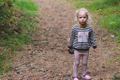 Portrait of boy standing on field