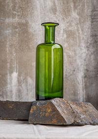 Close-up of glass of bottle against white background