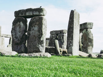 Stone structure on field against sky