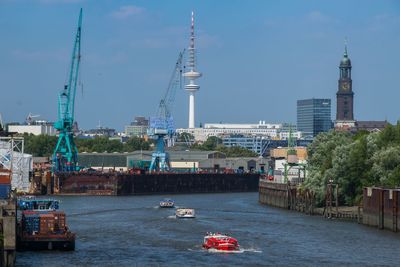 Boats in river with buildings in background