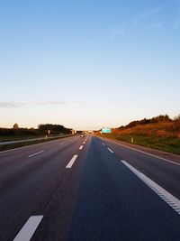 Highway against clear sky during sunset