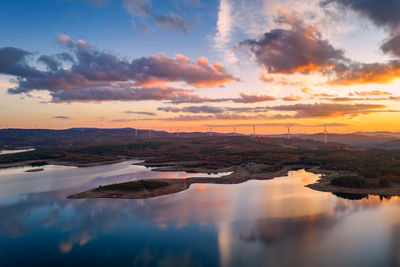 Drone aerial view of a lake reservoir of a dam with reflection on the water in sabugal, portugal