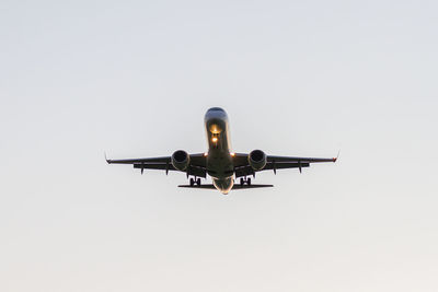 Low angle view of airplane against clear sky