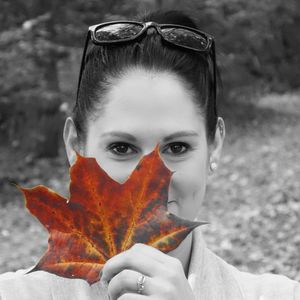 Close-up portrait of young woman in autumn