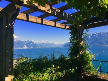 Scenic view of sea and mountains against sky