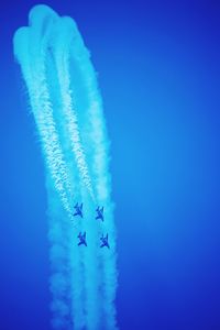 Aerial view of vapor trails in blue sky