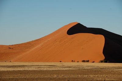 Scenic view of desert against clear sky