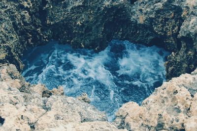 High angle view of rocks in sea