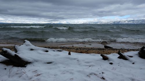 Scenic view of beach against sky during winter