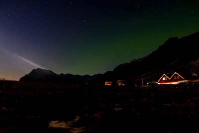 Scenic view of illuminated mountain against sky at night