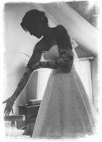 Low angle view of young woman sitting on stairs at home