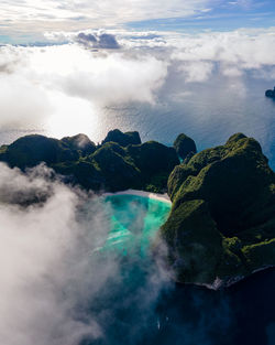 Aerial view of sea and rocks against sky